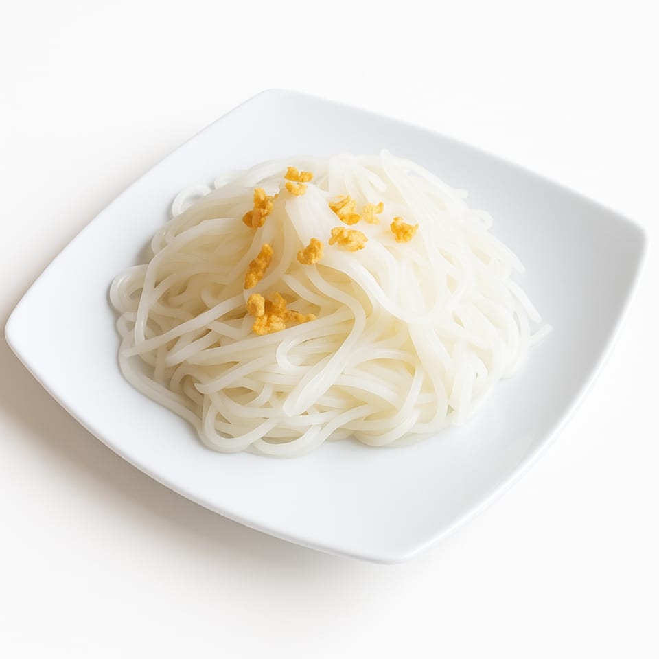 White rice noodles topped with crispy fried garlic on a square white plate.
