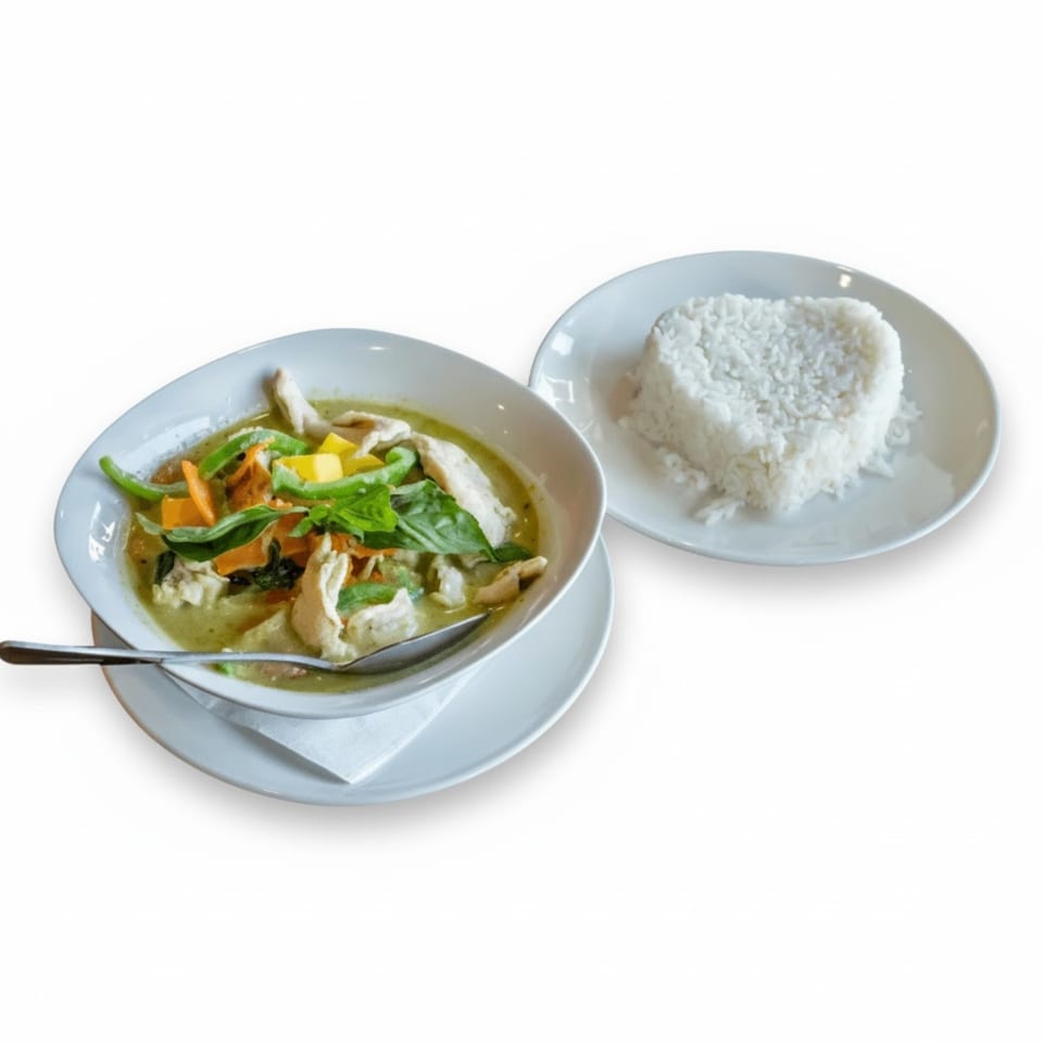 Jaidee Thai green curry with chicken and vegetables, served with a side of heart-shaped white rice.
