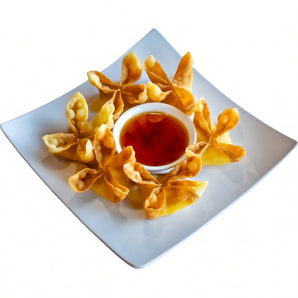 Crispy golden crab rangoons arranged around a small bowl of sweet chili dipping sauce on a white plate.